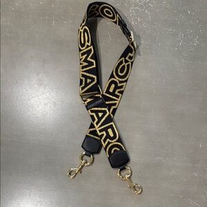 Marc Jacob’s Black and Gold Strap with Bold Lettering